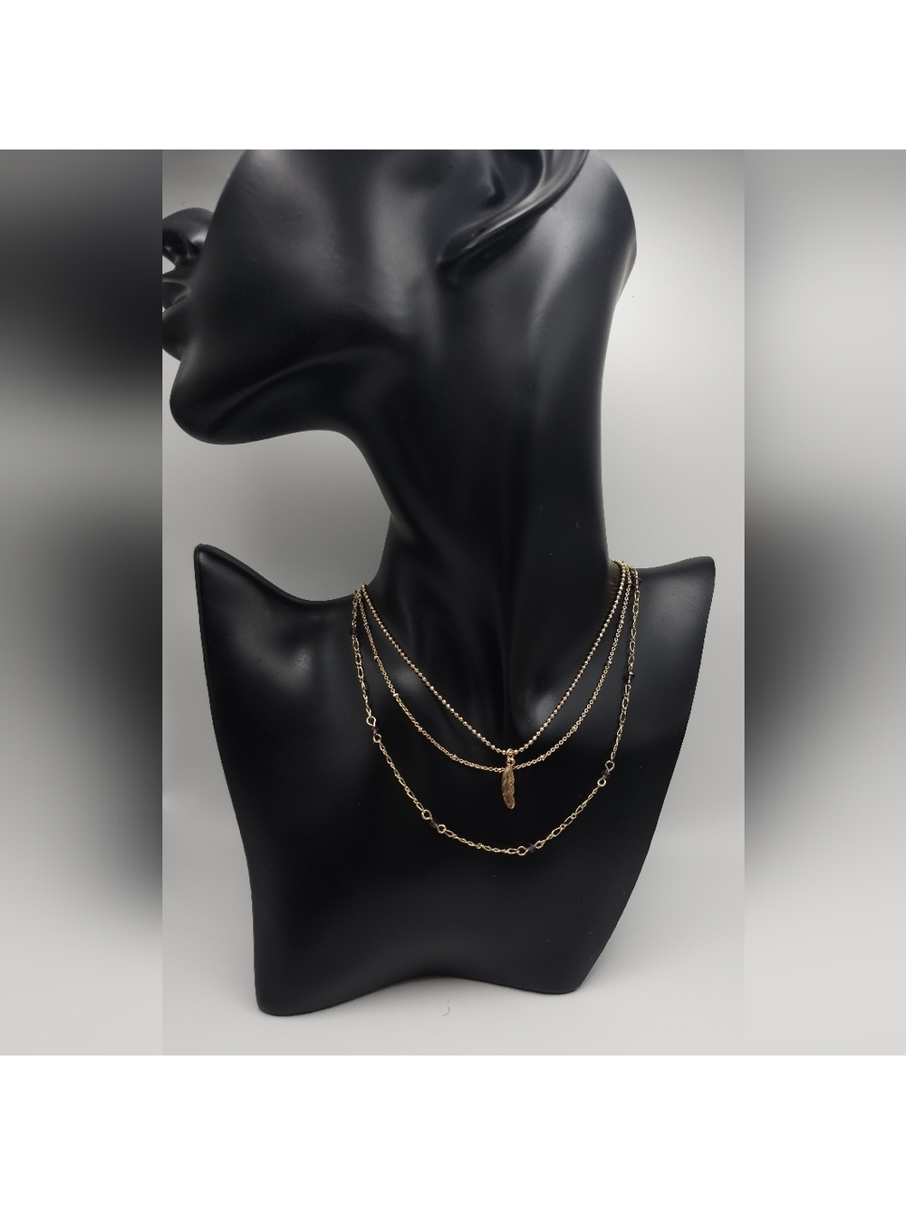Layered chain feather charm necklace